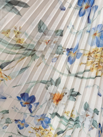 Floral patterned fabric with blue, yellow, and green flowers on a pleated background- Flowy fabric